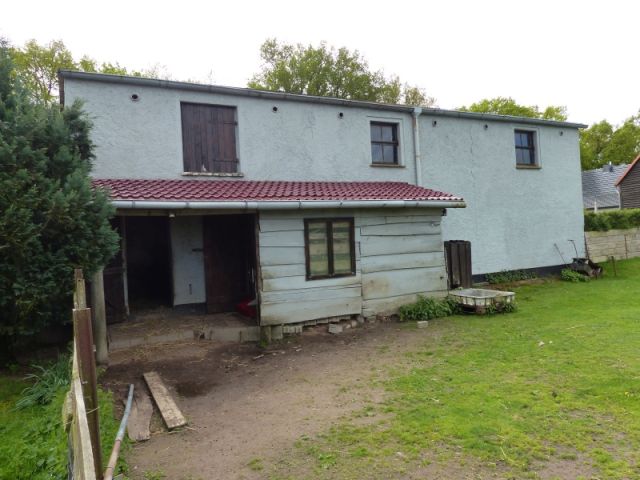 Blick auf Anbau auf der Verkaufsfläche und angrenzende Nachbarbebauung - Vertragslos als Weideland genutzte Grünfläche im Randbereich einer Wohnsiedlung in Meyenburg in der Prignitz