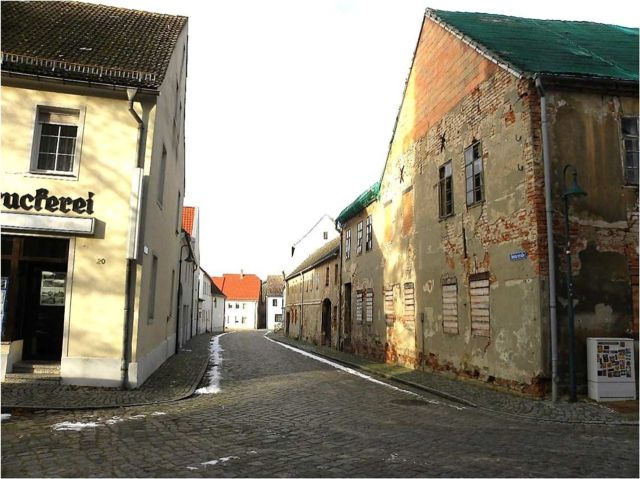 Verkaufsobjekt rechts und Umgebung - Denkmalgeschütztes, ruinöses Wohn- und Geschäftshaus mit Nebengebäuden gegenüber der Stadtkirche St. Marien